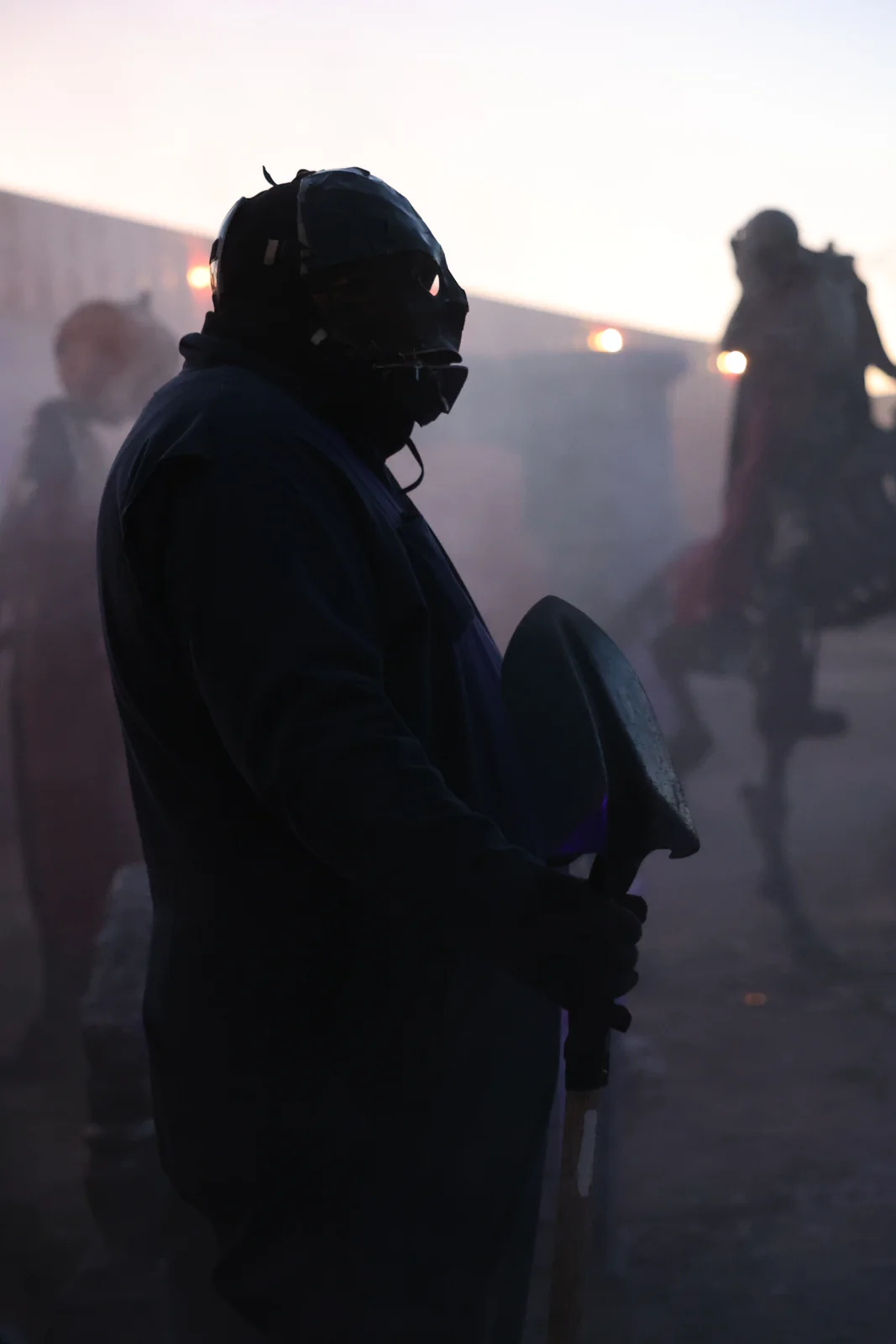 A masked performer stands in the fog at Nightmare Farms in Sherman.