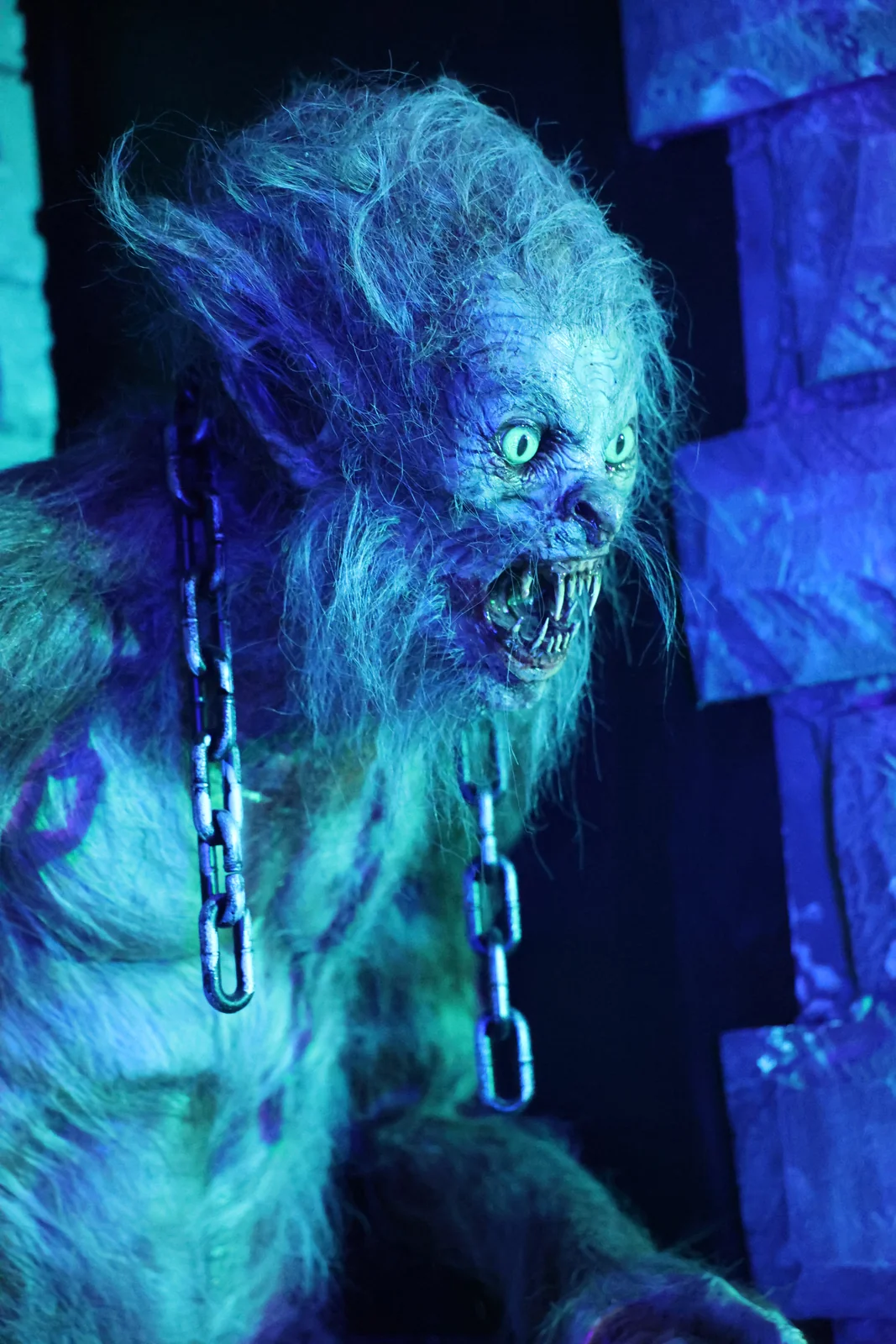 A blue-lit werewolf figure inside Nightmare Farms.